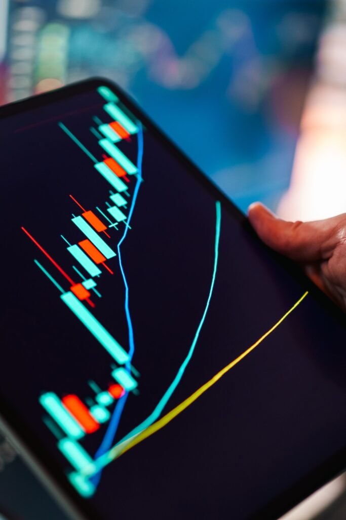 A close-up of a tablet displaying a colorful candlestick chart, ideal for finance and technology themes.